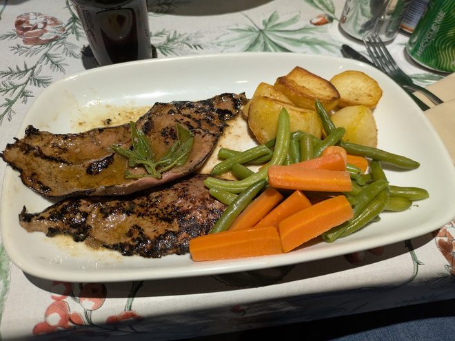 A grilled plate with potatoes and vegetables.